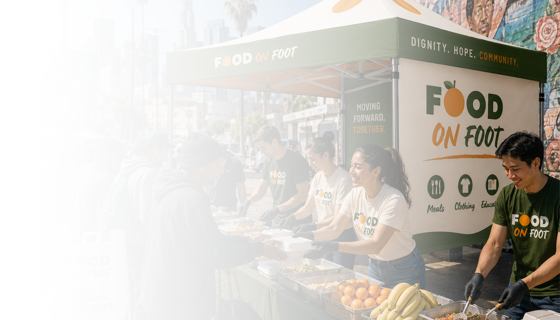 Food on Foot volunteers serving meals from the branded tent at a Sunday serving in Los Angeles